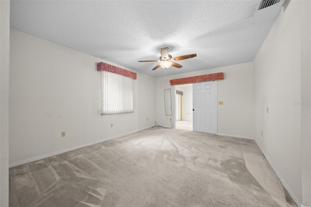 carpeted empty room featuring a textured ceiling and ceiling fan