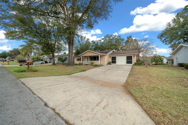 ranch-style house featuring a garage, a front lawn, and covered porch