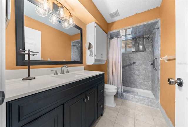 bathroom with toilet, vanity, tile patterned flooring, a textured ceiling, and curtained shower