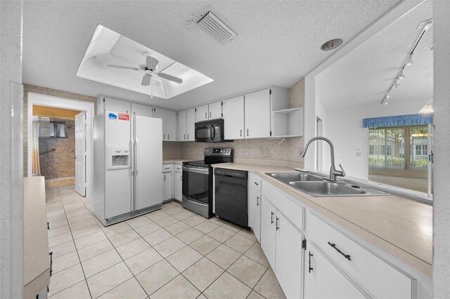 kitchen with black appliances, white cabinetry, sink, light tile patterned flooring, and ceiling fan