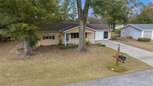 ranch-style home featuring covered porch, a front yard, and a garage