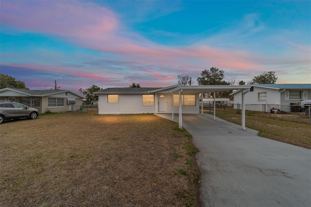 view of front of home with a yard and a carport