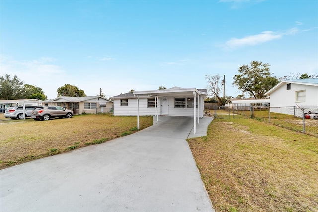 view of front facade with a front yard and a carport