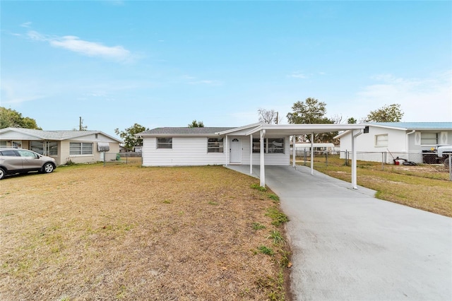 view of front facade with a front lawn and a carport