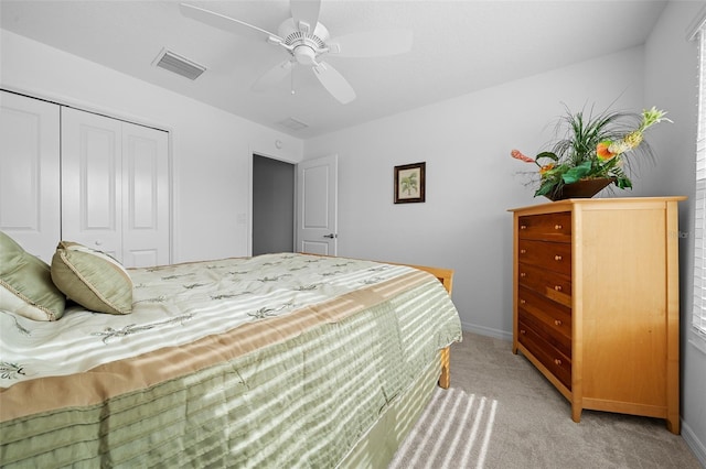 carpeted bedroom with a closet and ceiling fan