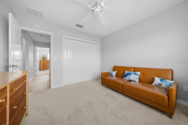 living room featuring ceiling fan and light carpet