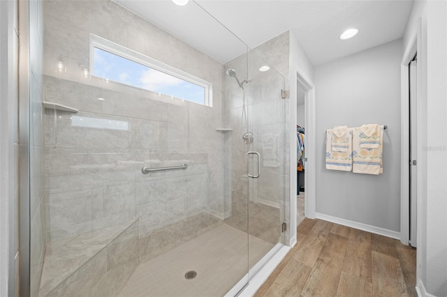 bathroom with wood-type flooring and walk in shower