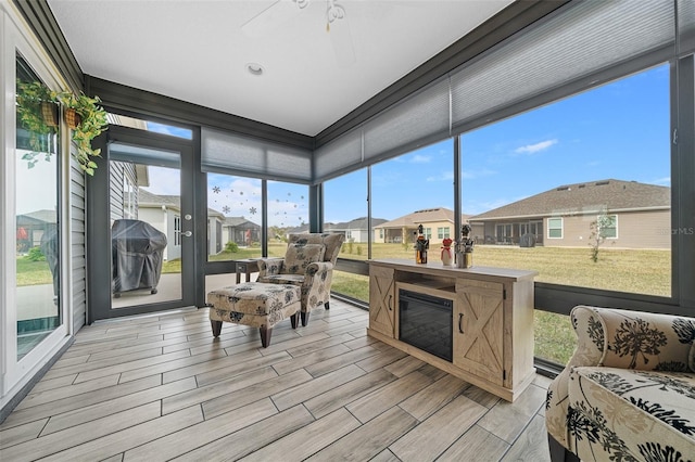 sunroom / solarium featuring ceiling fan and a wealth of natural light