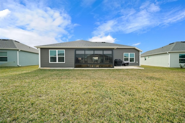 rear view of house featuring a yard and a patio