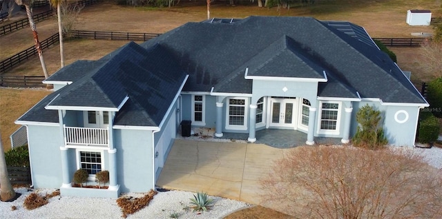 back of property featuring a patio and a balcony