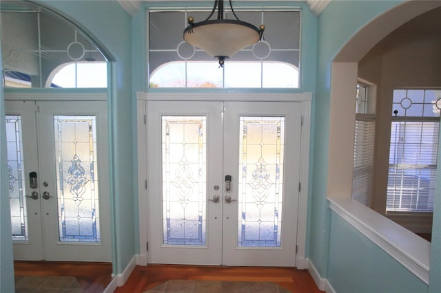 entrance foyer featuring dark hardwood / wood-style flooring and french doors