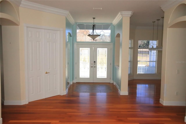 foyer with ornamental molding, dark wood-type flooring, and french doors