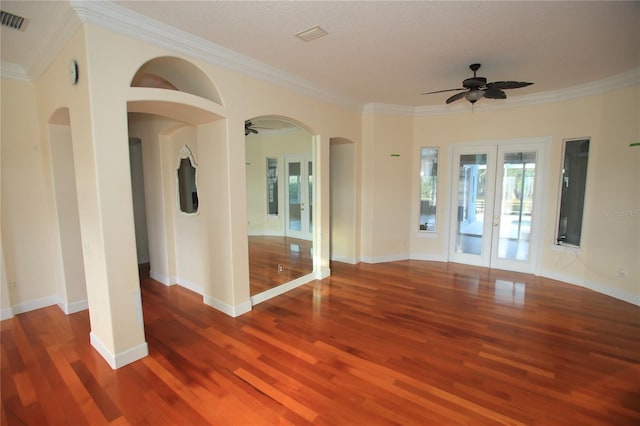 unfurnished room featuring french doors, ceiling fan, ornamental molding, and a wealth of natural light