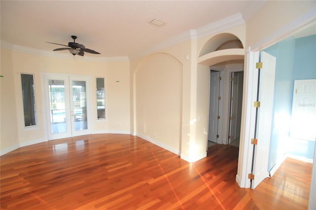 empty room featuring crown molding, hardwood / wood-style flooring, french doors, and ceiling fan