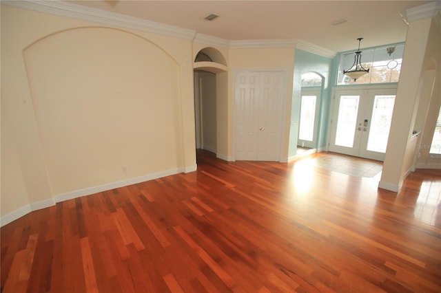 spare room featuring hardwood / wood-style flooring, ornamental molding, and french doors