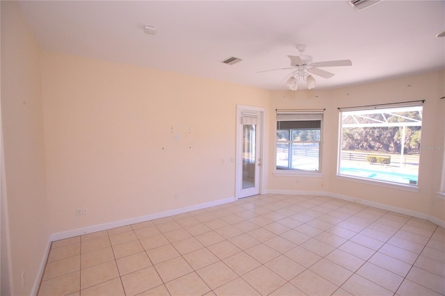 unfurnished room featuring ceiling fan and light tile patterned floors