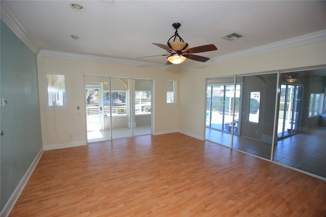 empty room with crown molding, a textured ceiling, ceiling fan, and light wood-type flooring