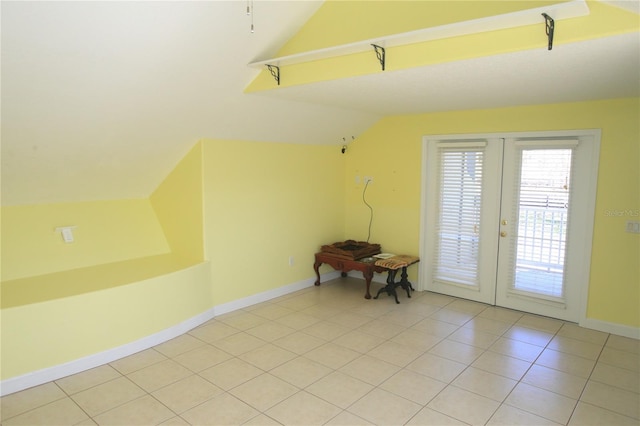 bonus room with vaulted ceiling, light tile patterned floors, and french doors