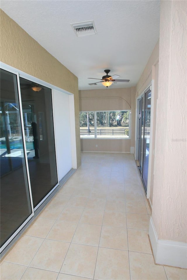 hall with light tile patterned flooring