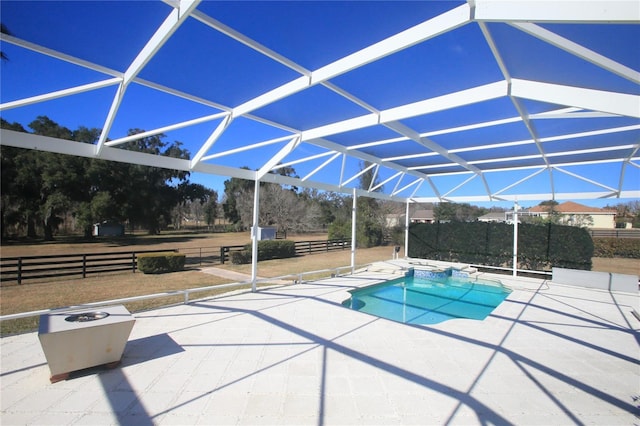 view of pool featuring a patio and glass enclosure