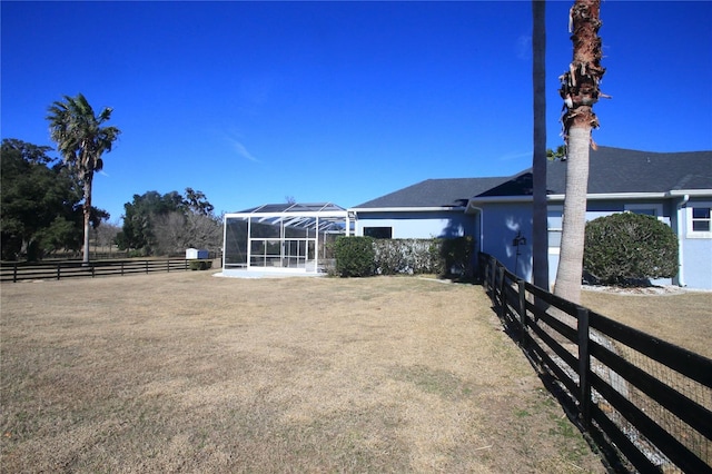 view of yard featuring glass enclosure