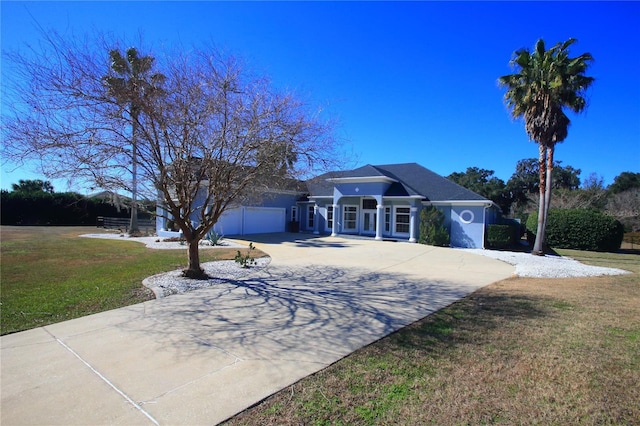 single story home featuring a garage and a front yard