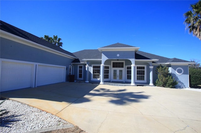 view of front of house with a garage and french doors