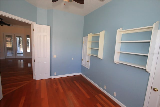 unfurnished bedroom featuring ceiling fan and dark hardwood / wood-style floors