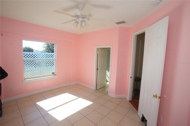 unfurnished bedroom with light tile patterned floors and ceiling fan