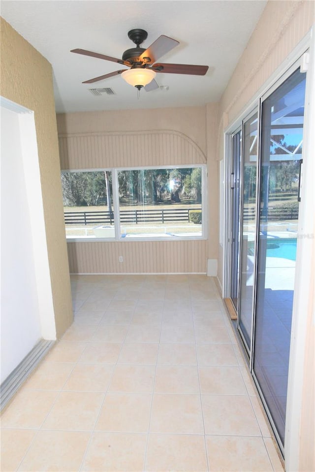 interior space featuring ceiling fan and light tile patterned flooring