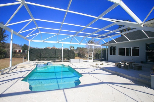 view of pool with a patio and glass enclosure