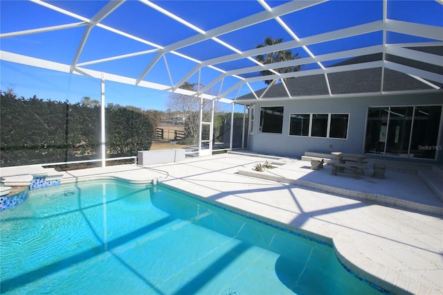 view of swimming pool featuring a lanai and a patio