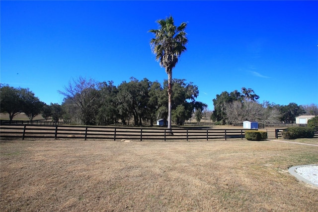 view of yard with a rural view