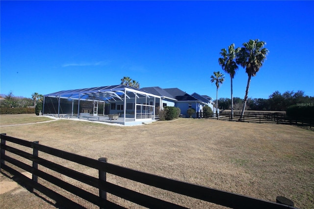 view of yard with glass enclosure