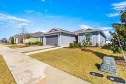 ranch-style home with a garage and a front yard