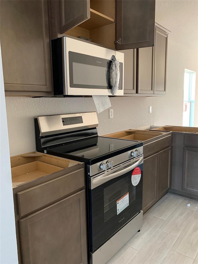 kitchen featuring dark brown cabinets and stainless steel appliances