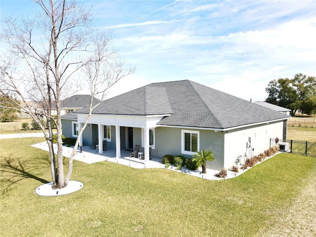 back of house featuring a patio area and a yard