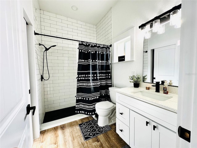 bathroom featuring hardwood / wood-style flooring, curtained shower, toilet, and vanity