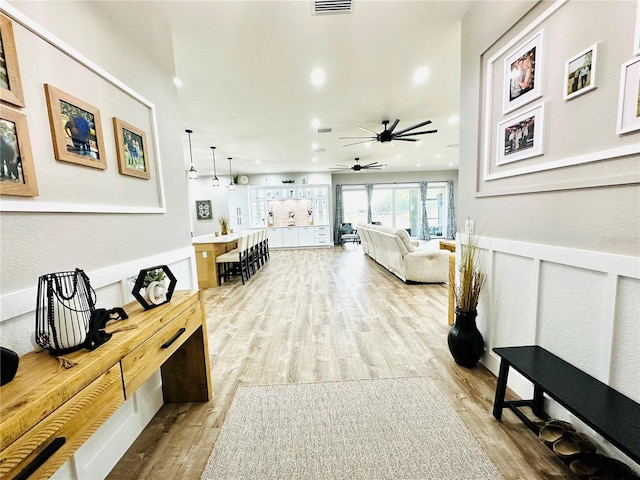 living room featuring ceiling fan and light wood-type flooring