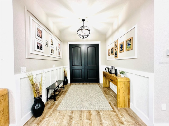 foyer with an inviting chandelier and light hardwood / wood-style floors