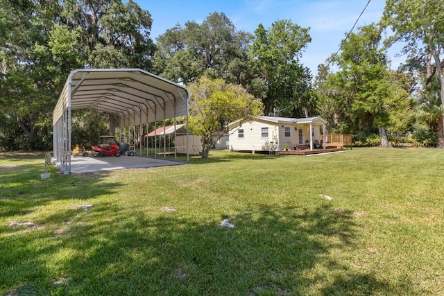 view of yard with a storage unit, a deck, and a carport