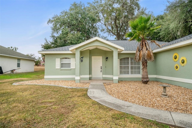 ranch-style house featuring a front yard