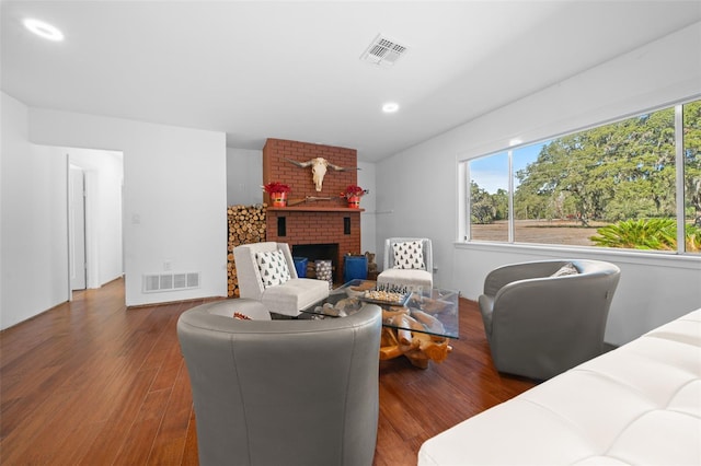 living room with dark hardwood / wood-style floors and a fireplace