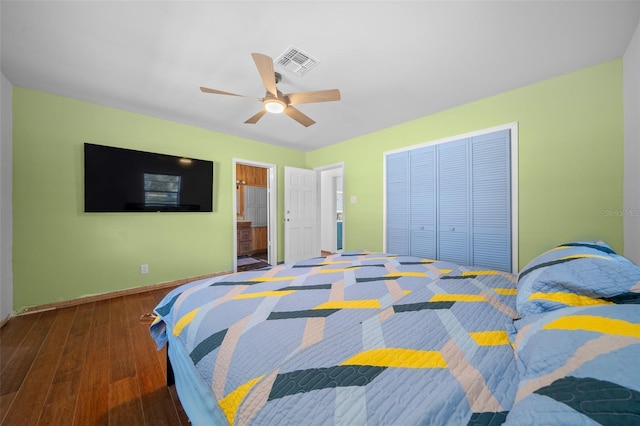 bedroom with ceiling fan, ensuite bathroom, a closet, and dark hardwood / wood-style floors