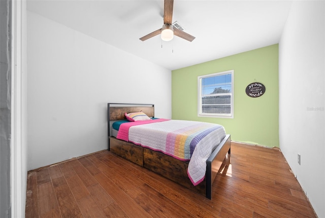 bedroom with ceiling fan and hardwood / wood-style flooring