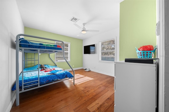 bedroom with ceiling fan and wood-type flooring