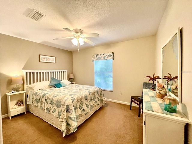 bedroom with ceiling fan, a textured ceiling, and light colored carpet