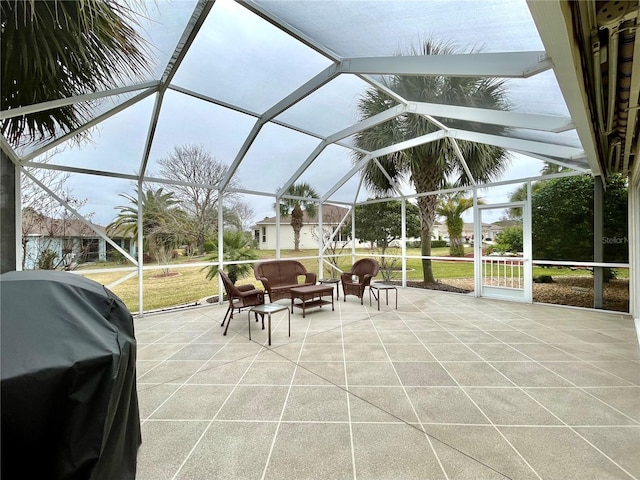 view of patio with a grill and a lanai