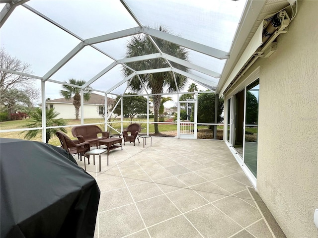 view of patio / terrace featuring glass enclosure and area for grilling