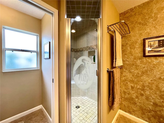 bathroom with tile patterned flooring and a shower with door